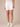 absolution optic white stretch denim 7" roll hem shorts